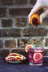 Midsection of person preparing food in glass