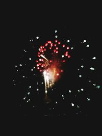 Low angle view of firework display at night