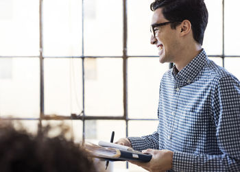 Smiling businessman sharing ideas in office