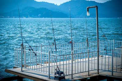 Scenic view of sea against sky with fishing rod