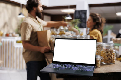 Young woman using laptop at table