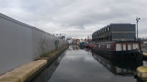 Boats in canal along buildings