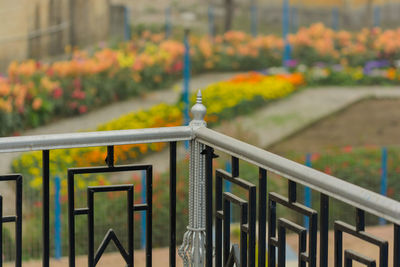 Metal fence by railing at park