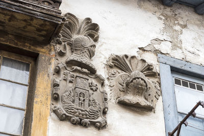 Low angle view of statues on old building