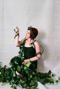 Young woman standing in plants 