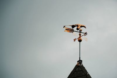 Low angle view of weather vane