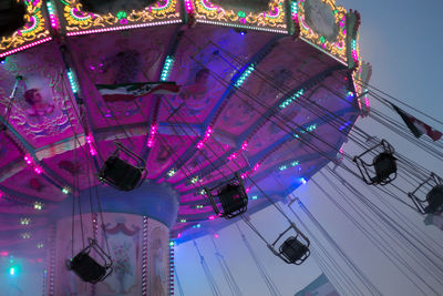 Low angle view of illuminated ferris wheel against sky