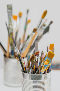 Close-up of paintbrushes against white background