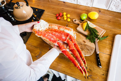 High angle view of person preparing food on cutting board