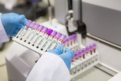 Cropped hands of scientist holding test tubes