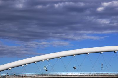 Low angle view of bridge against cloudy sky