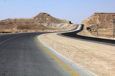 Scenic view of mountain road against clear sky