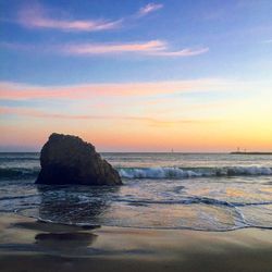 Scenic view of calm sea against sky during sunset