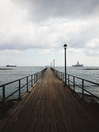 Pier over sea against sky