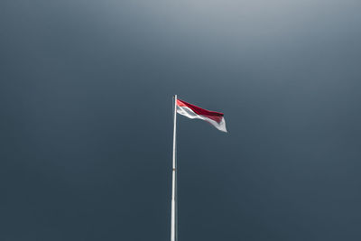 Low angle view of flag against sky