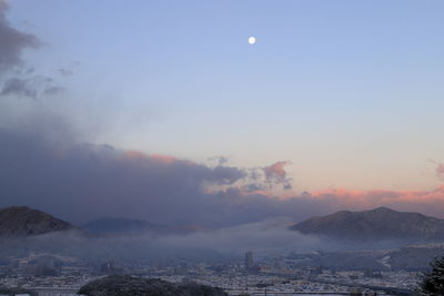 Scenic view of mountains against sky at sunset