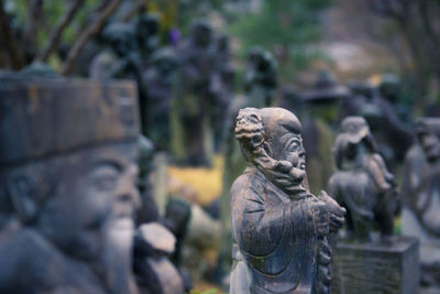 Close-up of statue against stone wall