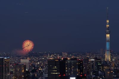 Firework display over city at night