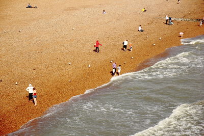 High angle view of people walking on beach