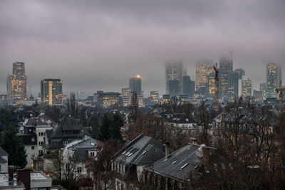 High angle view of buildings in city against sky