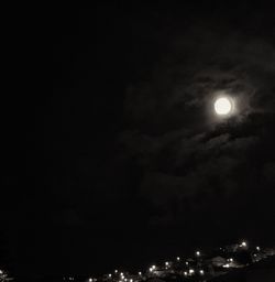 Illuminated city against sky at night