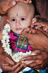 Close-up portrait of father holding baby