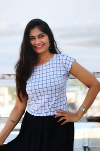 Portrait of a smiling young woman standing outdoors