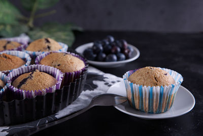 Delicious homemade cupcakes filled with blueberries and presented in small molds.