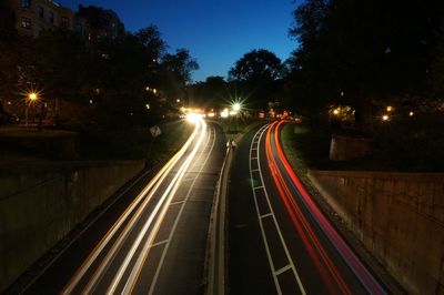 Light trails on road in city at night