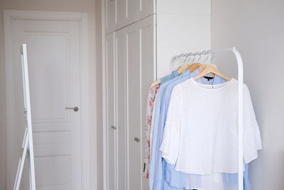 Rack with hanging clothes in the interior of the dressing room.