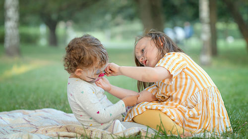 Side view of mother and daughter in park