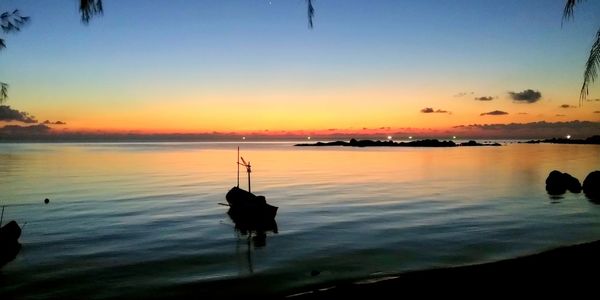 Scenic view of lake against sky during sunset