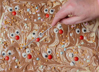 White and brown chocolate with sugar faces in preparation for broken chocolate