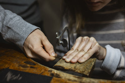 Midsection of woman working in workshop