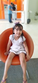 Smiling girl sitting on chair