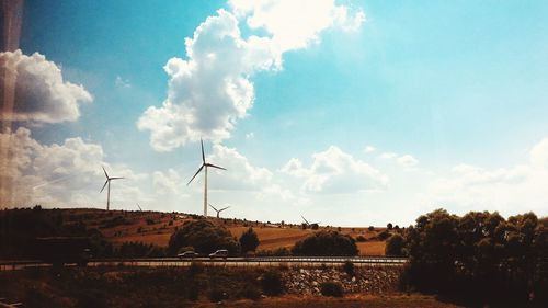 Windmill on field against sky