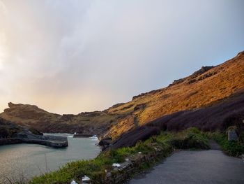 Scenic view of river amidst mountains against sky