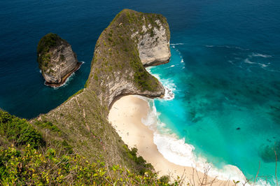 High angle view of rocks on sea shore