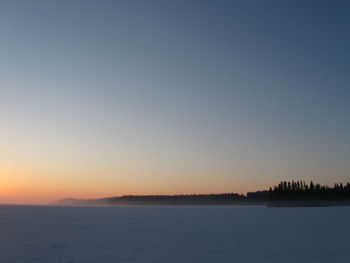 Scenic view of sea against clear sky during sunset