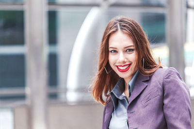 Close-up portrait of happy young woman in city