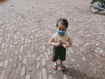 High angle view of boy standing on street