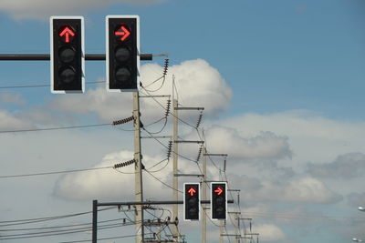 Low angle view of road signal against sky