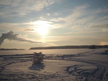 Scenic view of beach against sky during sunset