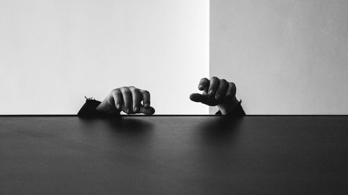 Cropped hands by table at home