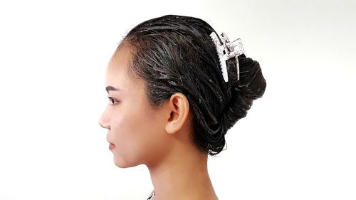 Side view of woman against white background