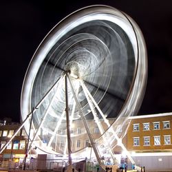 Low angle view of ferris wheel against sky at night