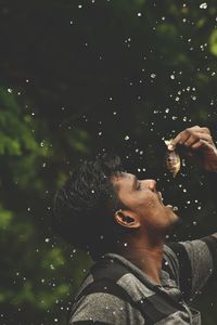 Portrait of man holding fish at darkmood