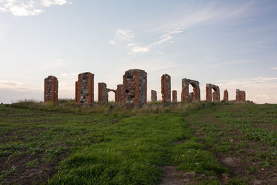 Old ruin on field against sky