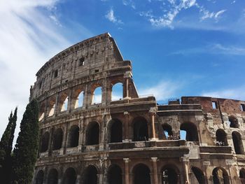 Low angle view of coliseum against sky