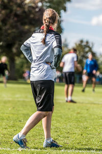 Full length rear view of woman on playing field
